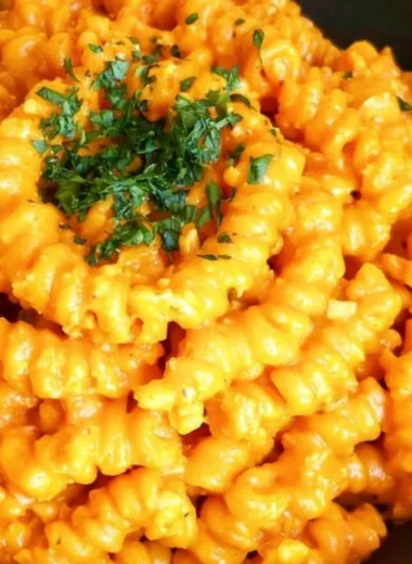 Bowl of Gochujang Pasta topped with fresh herbs and chili flakes