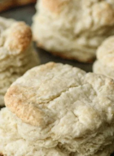 Freshly baked homemade buttery biscuits on a kitchen table