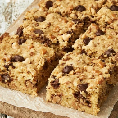 Delicious loaded chocolate chip cookie bars with chocolate chunks and nuts.
