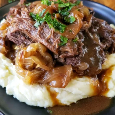 Delicious melt-in-your-mouth pot roast served with vegetables and gravy.