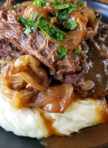 Delicious melt-in-your-mouth pot roast served with vegetables and gravy.