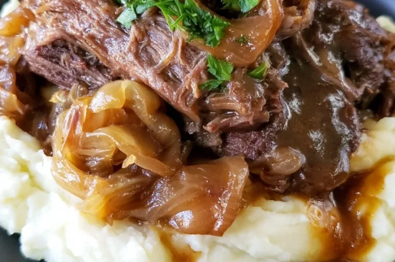 Delicious melt-in-your-mouth pot roast served with vegetables and gravy.