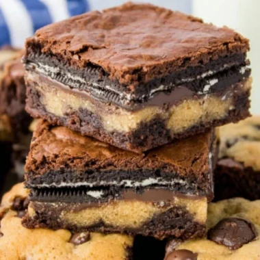 Delicious Oreo brownies with cookie dough layers topped with crushed Oreo cookies.