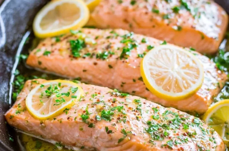Delicious oven roasted salmon garnished with herbs and lemon slices