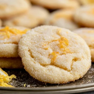 Soft and chewy lemon cookies on a baking sheet, freshly baked and golden.