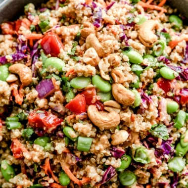Colorful Thai quinoa salad with fresh vegetables, herbs, and a zesty dressing
