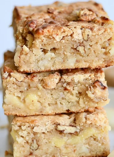 Delicious homemade cozy apple brownies topped with cinnamon and walnuts