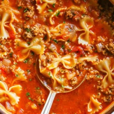 A bowl of savory one-pot lasagna soup topped with cheese and herbs.
