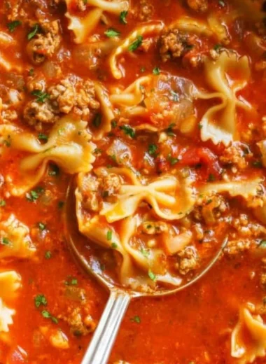 A bowl of savory one-pot lasagna soup topped with cheese and herbs.