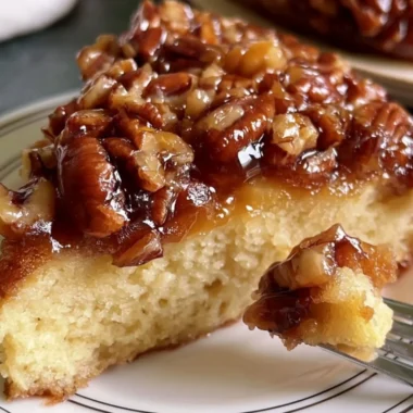 Delicious Upside Down Caramel Pecan Cake topped with caramel and pecans.